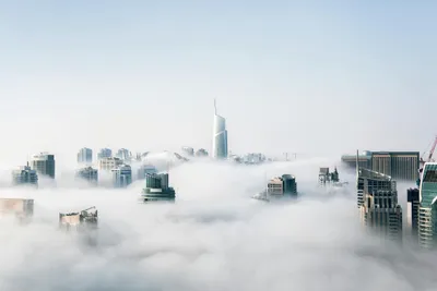 City skyline peeking out of the clouds